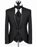A black double-breasted formal suit displayed on a mannequin, featuring a textured jacquard pattern, satin peak lapels, a matching vest, tie, and cravat, with a white shirt underneath.