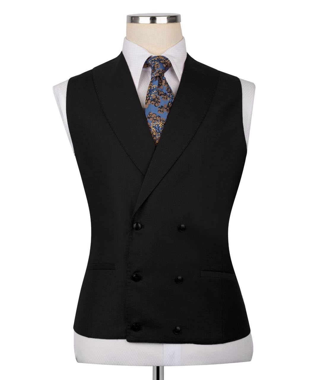 Black double-breasted suit vest on a mannequin with a white shirt and patterned tie.