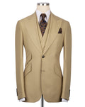A beige single-breasted suit jacket displayed on a mannequin torso, styled with a white dress shirt, a patterned brown and gold tie, and a matching pocket square against a plain white background.