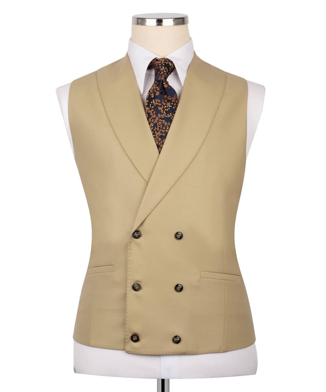 A beige double-breasted waistcoat displayed on a white dress form mannequin, styled with a white collared shirt and a dark patterned tie, against a plain white background.