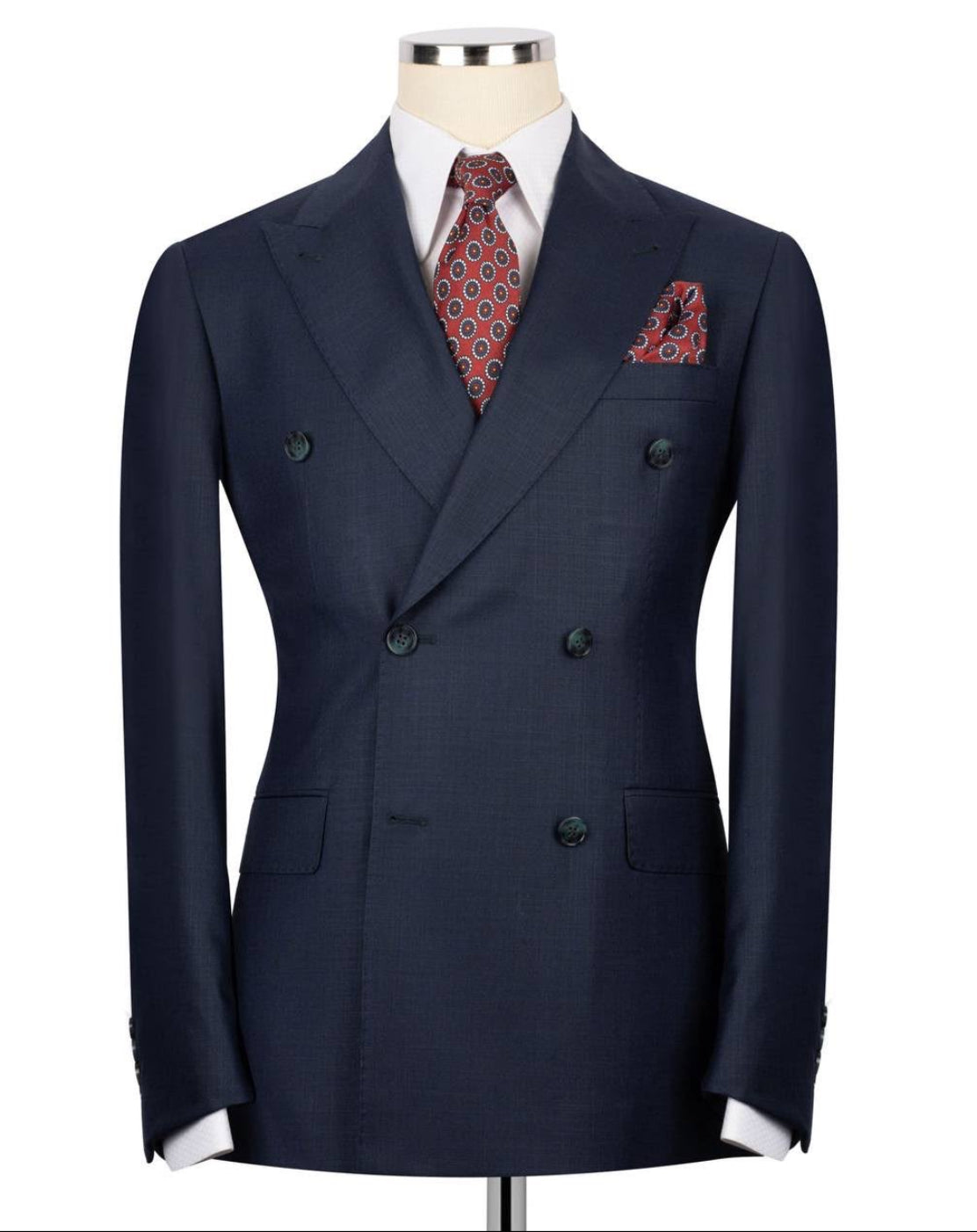 Navy double-breasted suit jacket with a patterned tie and pocket square on a mannequin against a white background.