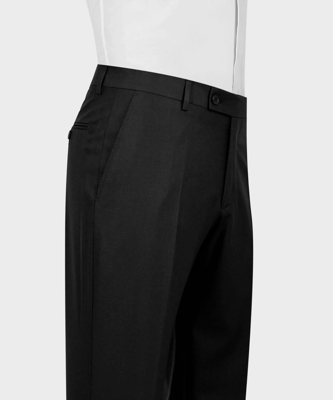 Close-up of black tailored trousers shown on a mannequin torso with a white shirt