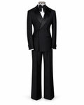 A black double-breasted tuxedo suit with satin lapels, shown on a mannequin torso with a black bow tie and white dress shirt against a plain white background.