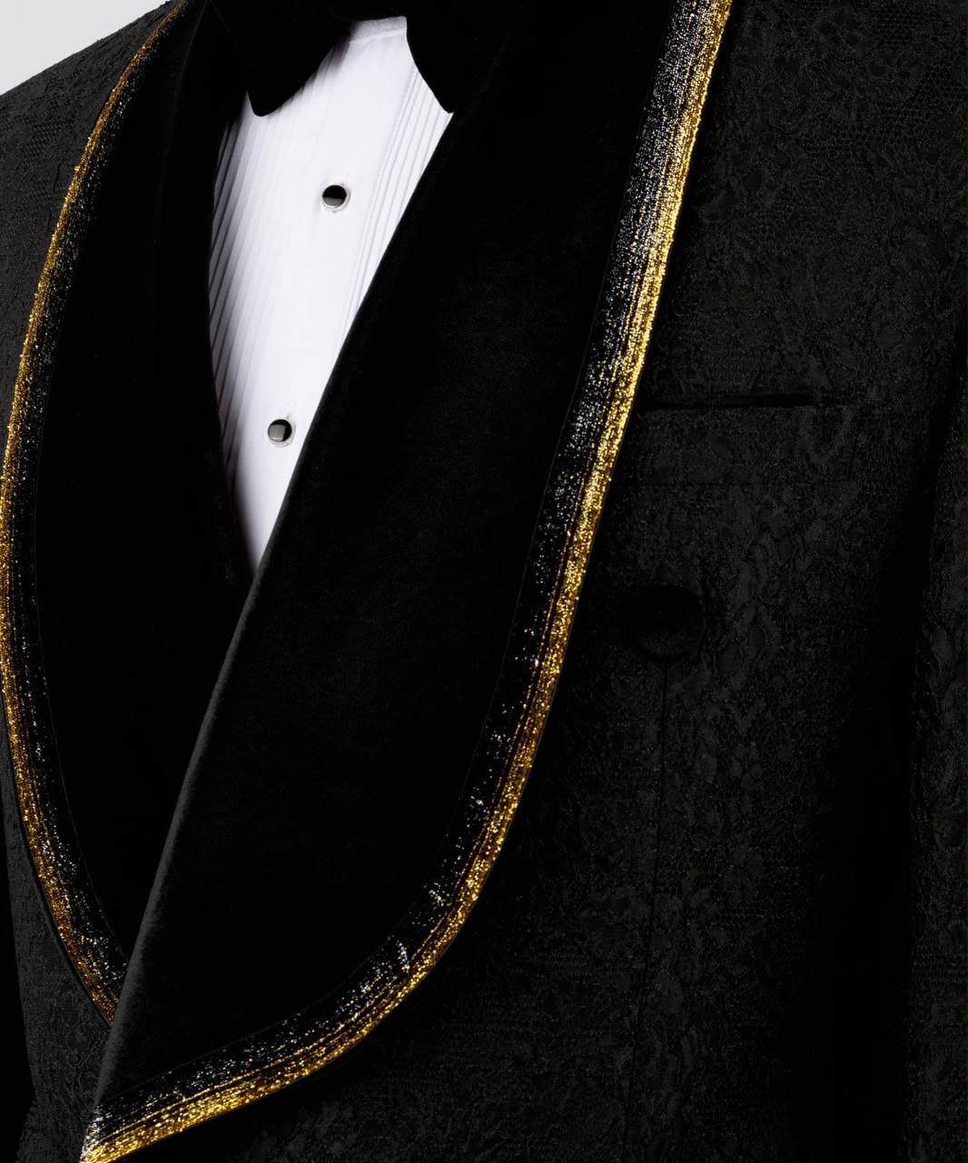 Close-up of a black tuxedo with gold trim 