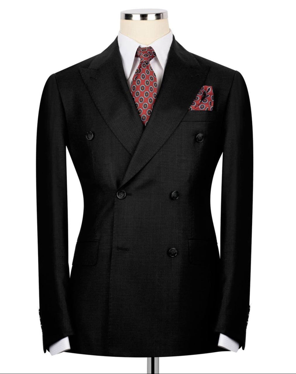 A black double-breasted suit jacket displayed on a mannequin torso, styled with a white dress shirt, a red and black patterned tie, and a matching pocket square against a plain white background.