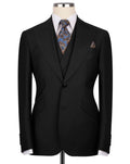 Black suit jacket on a mannequin with a patterned tie and pocket square 