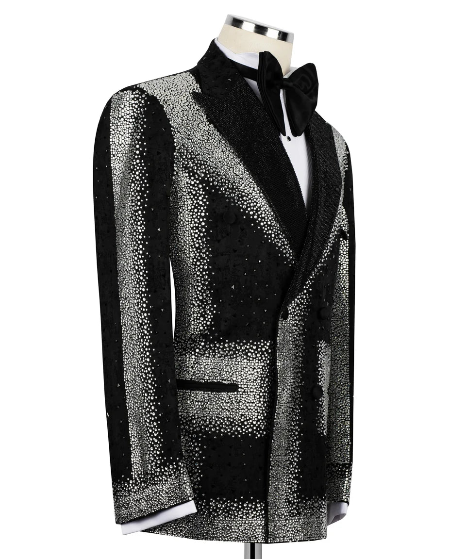 A men's tuxedo jacket with a black and silver glittery pattern, displayed on a mannequin torso with a black bow tie and white dress shirt against a plain white background.