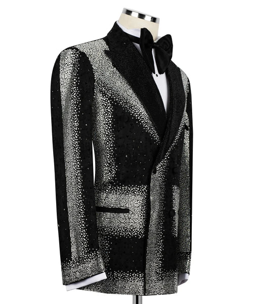 A men's tuxedo jacket with a black and silver glittery pattern, displayed on a mannequin torso with a black bow tie and white dress shirt against a plain white background.