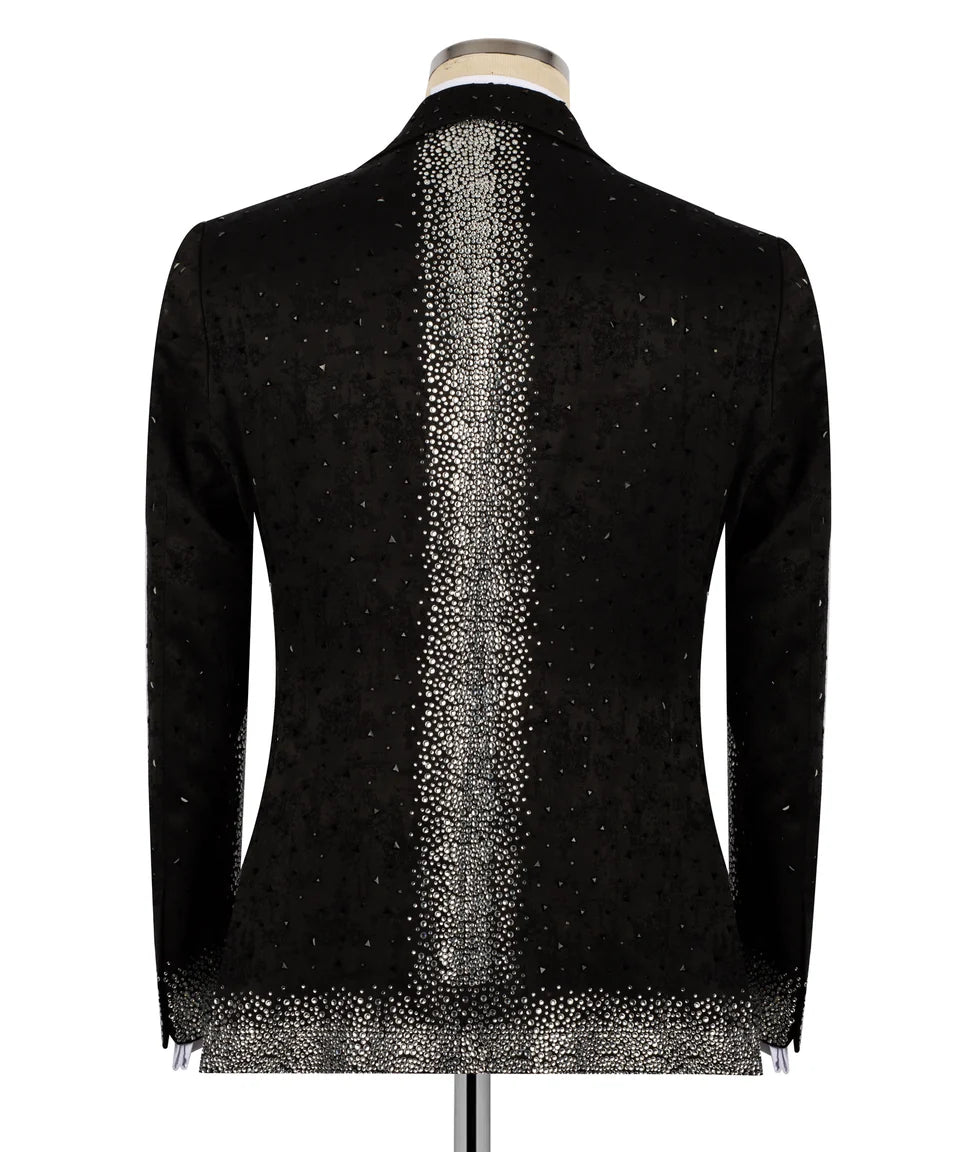 A black long-sleeve blazer jacket with a textured vertical silver glitter stripe down the center back, displayed on a mannequin against a white background.