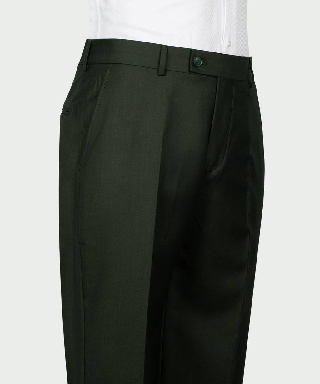 A close-up of a pair of dark olive green trousers worn with a white shirt, showing the front waistband, belt loops, 