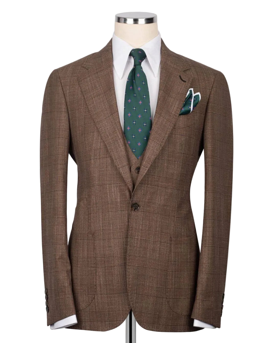 A brown plaid suit jacket displayed on a mannequin torso, styled with a white dress shirt, a green patterned tie, and a matching pocket square