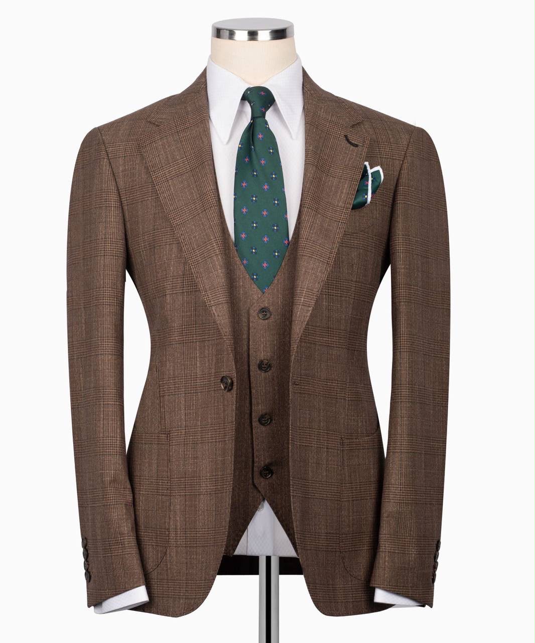 Brown checkered suit with a green tie and pocket square on a mannequin 