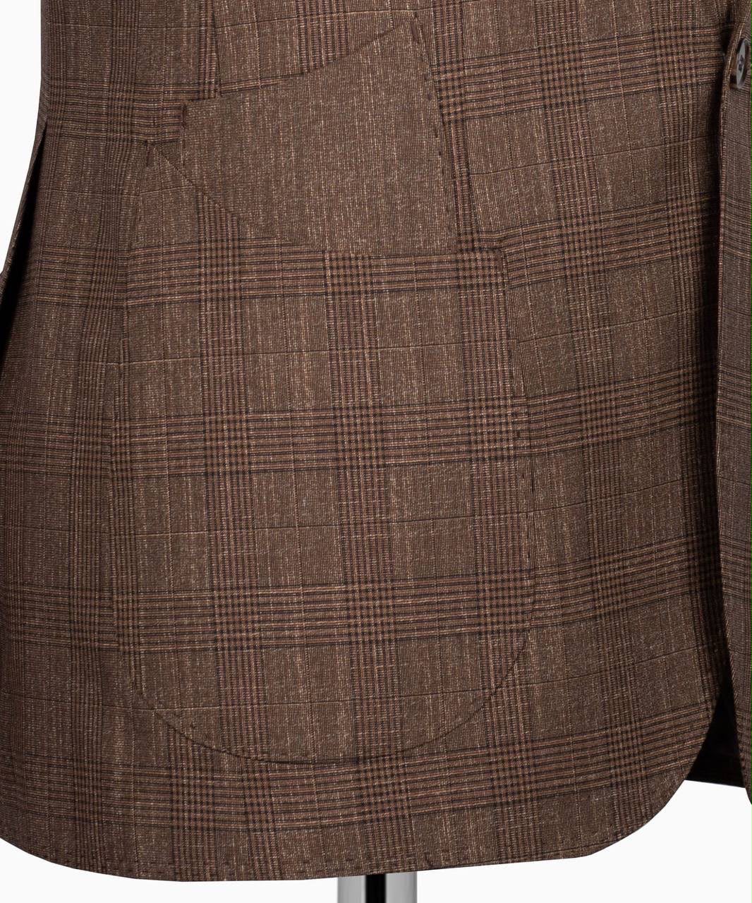 Close-up of a brown plaid wool blazer jacket with a single front patch pocket, displayed on a mannequin torso.