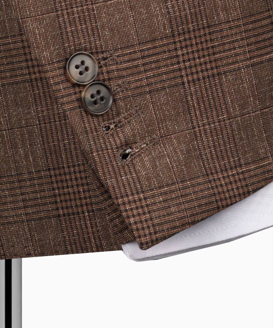 Close-up of a brown checkered fabric with two buttons 