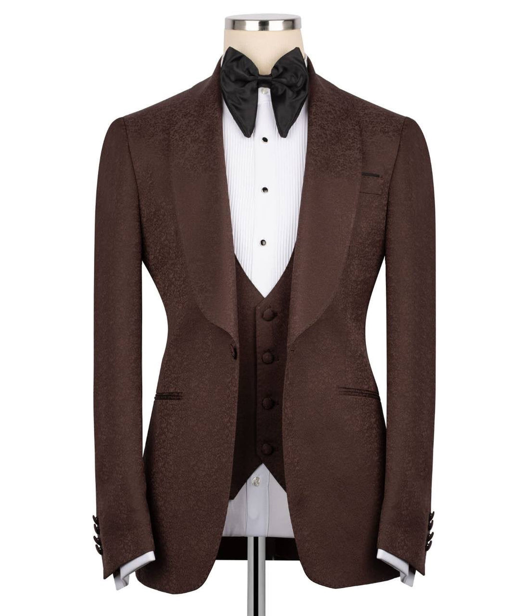 A men's brown textured tuxedo jacket displayed on a mannequin with a white pleated shirt, black bow tie, 