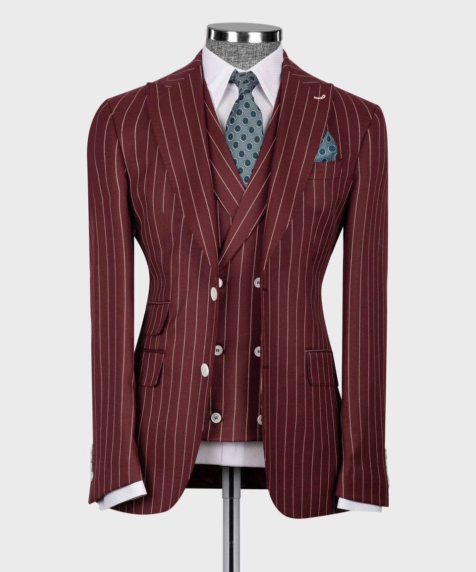 A men's three-piece suit displayed on a mannequin, featuring a maroon double-breasted jacket with thin white pinstripes, a matching waistcoat, and a white dress shirt. The suit is styled with a blue patterned tie and a matching pocket square against a light gray background.