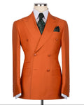 Orange double-breasted suit jacket on a mannequin with a white shirt and patterned tie.