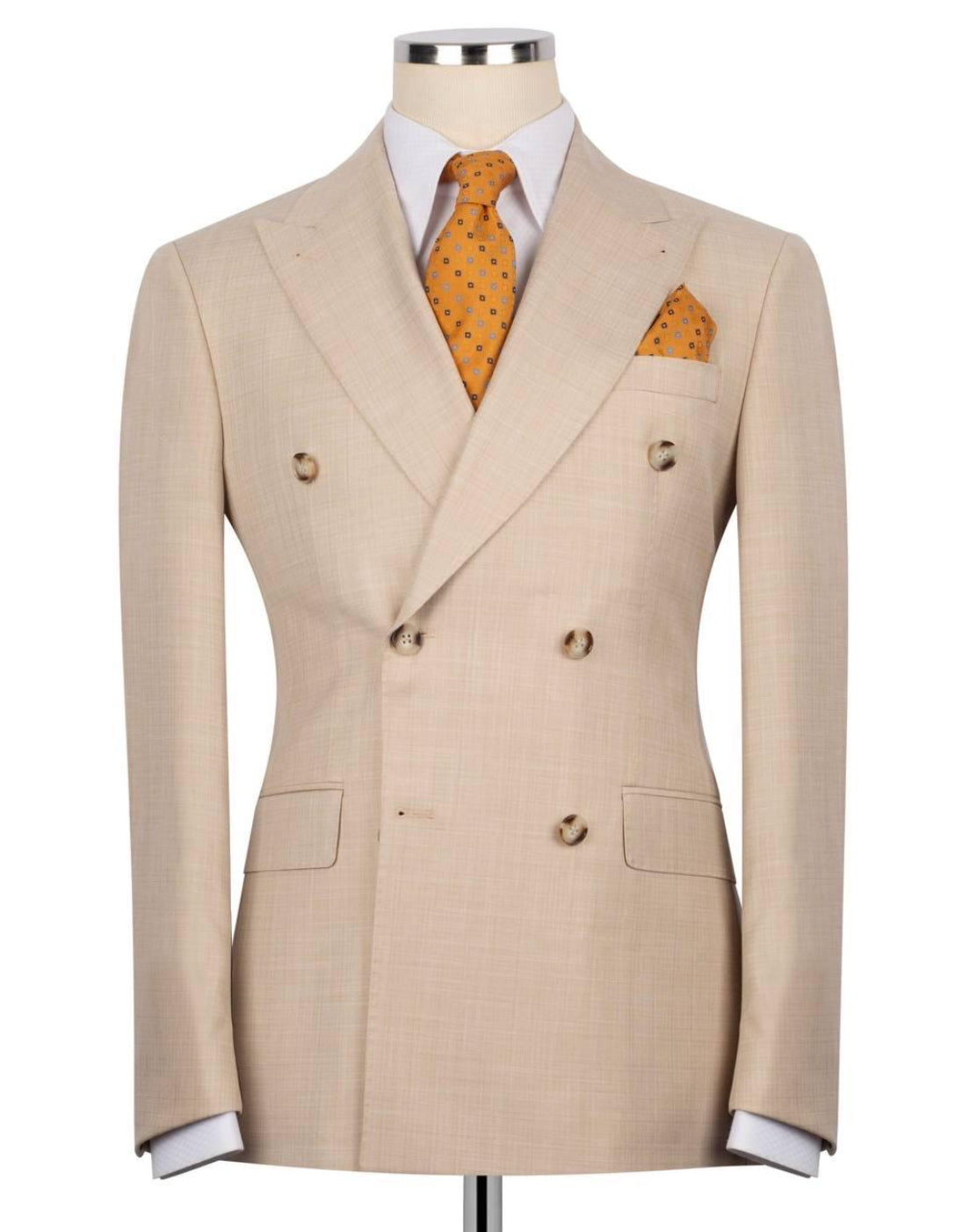 A beige double-breasted suit jacket displayed on a mannequin torso, styled with a white dress shirt, an orange patterned tie, and a matching orange pocket square against a plain white background.