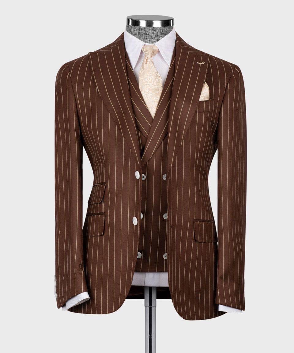 A brown pinstripe suit displayed on a mannequin torso, featuring a double-breasted jacket, matching vest, white dress shirt, pale gold tie, and a white pocket square against a light gray background.