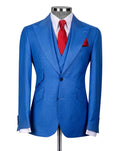 A men's blue textured two-piece suit displayed on a mannequin, styled with a white dress shirt, a red tie, and a matching red pocket square against a light gray background.