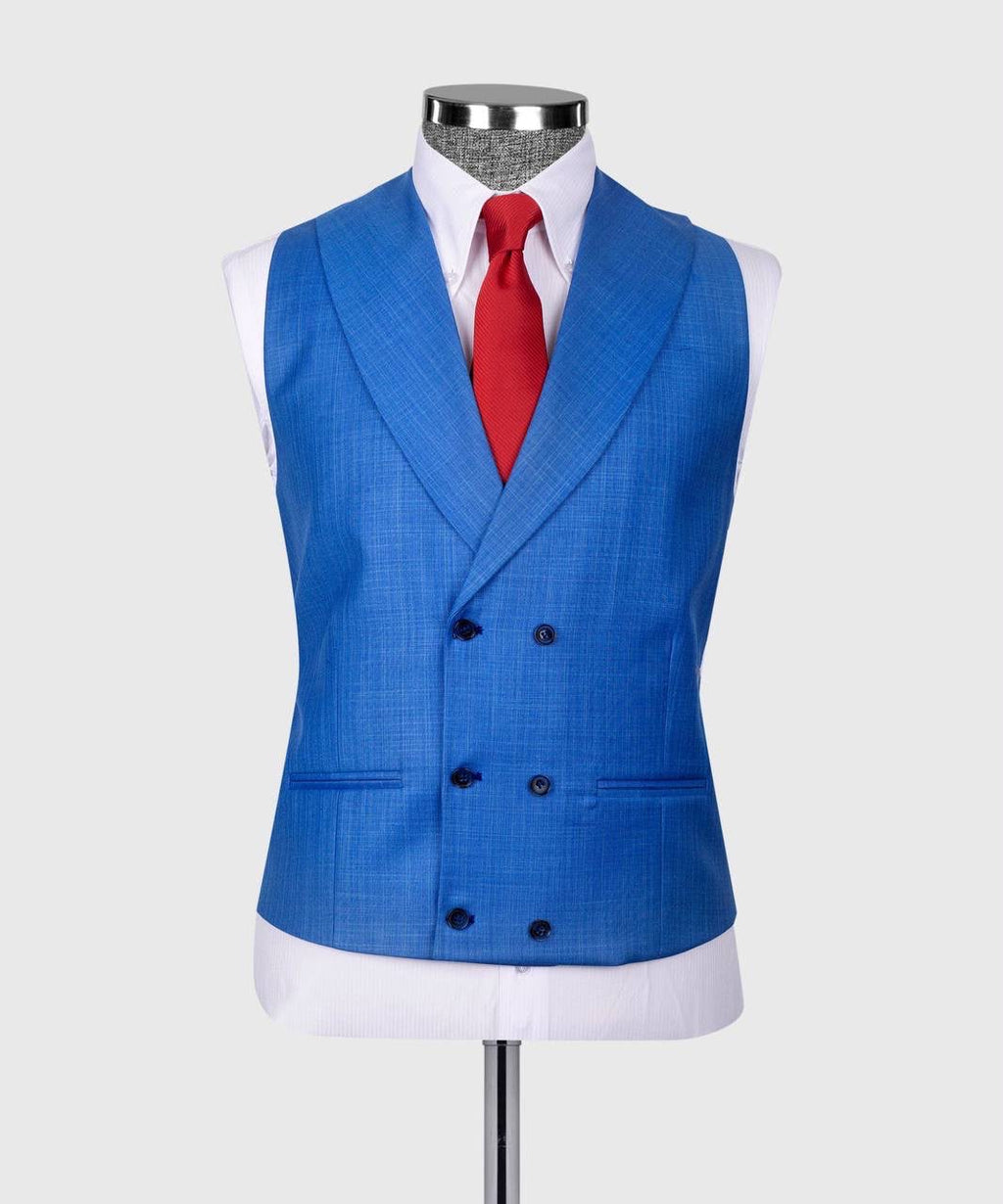 A men's double-breasted waistcoat in a vibrant medium blue with a subtle micro-texture, displayed on a mannequin torso styled with a white dress shirt and a red tie against a light gray background.