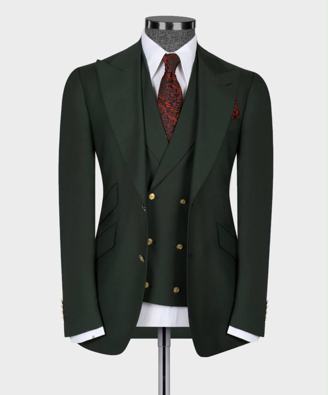 Dark green suit with a red patterned tie on a mannequin 