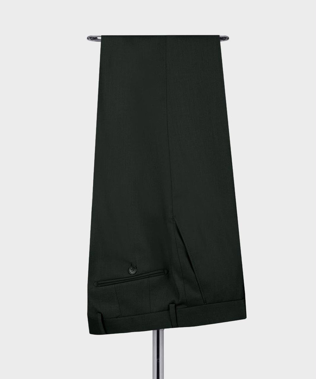 A pair of dark forest green trousers hanging from a metal stand 