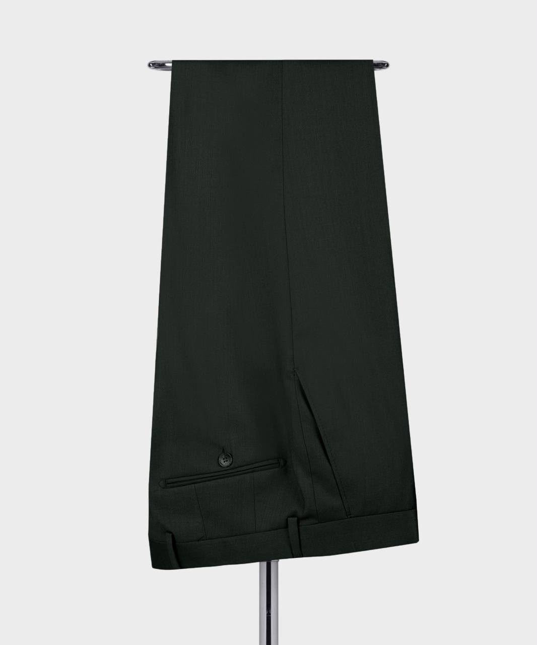 A pair of dark forest green trousers hanging from a metal stand 