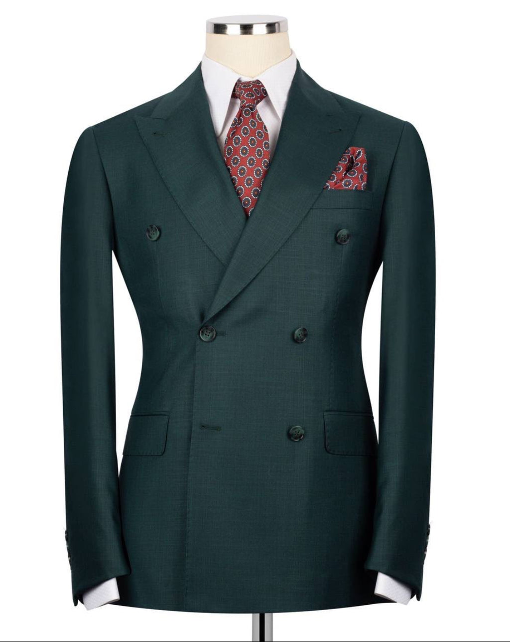 Green double-breasted suit jacket with a patterned tie and pocket square on a mannequin against a white background.