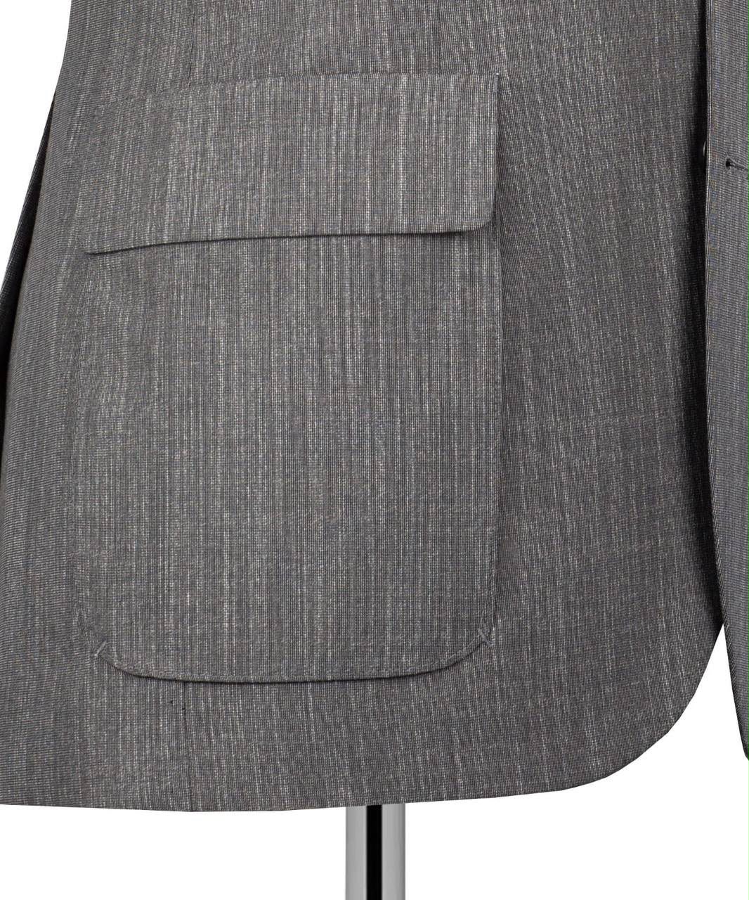 Close-up of a gray textured blazer jacket with a single front flap pocket, displayed on a mannequin against a white background.