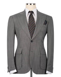 A gray pinstripe suit jacket displayed on a mannequin torso, styled with a white dress shirt, a patterned blue and brown tie, and a matching pocket square against a plain white background.