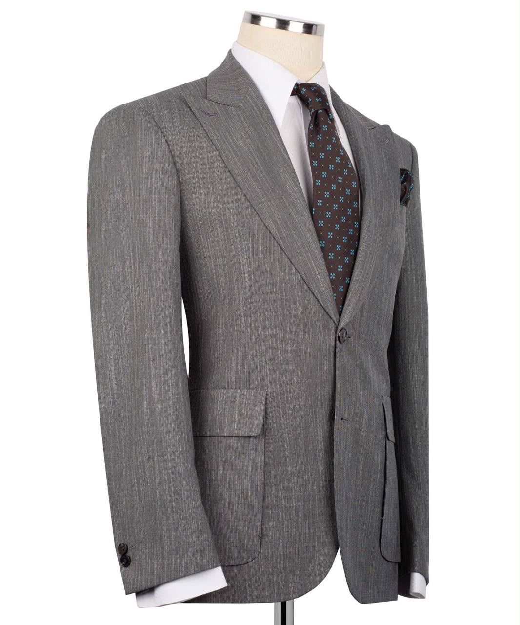 A men's gray pinstripe suit jacket displayed on a mannequin torso, styled with a white dress shirt and a patterned brown tie.