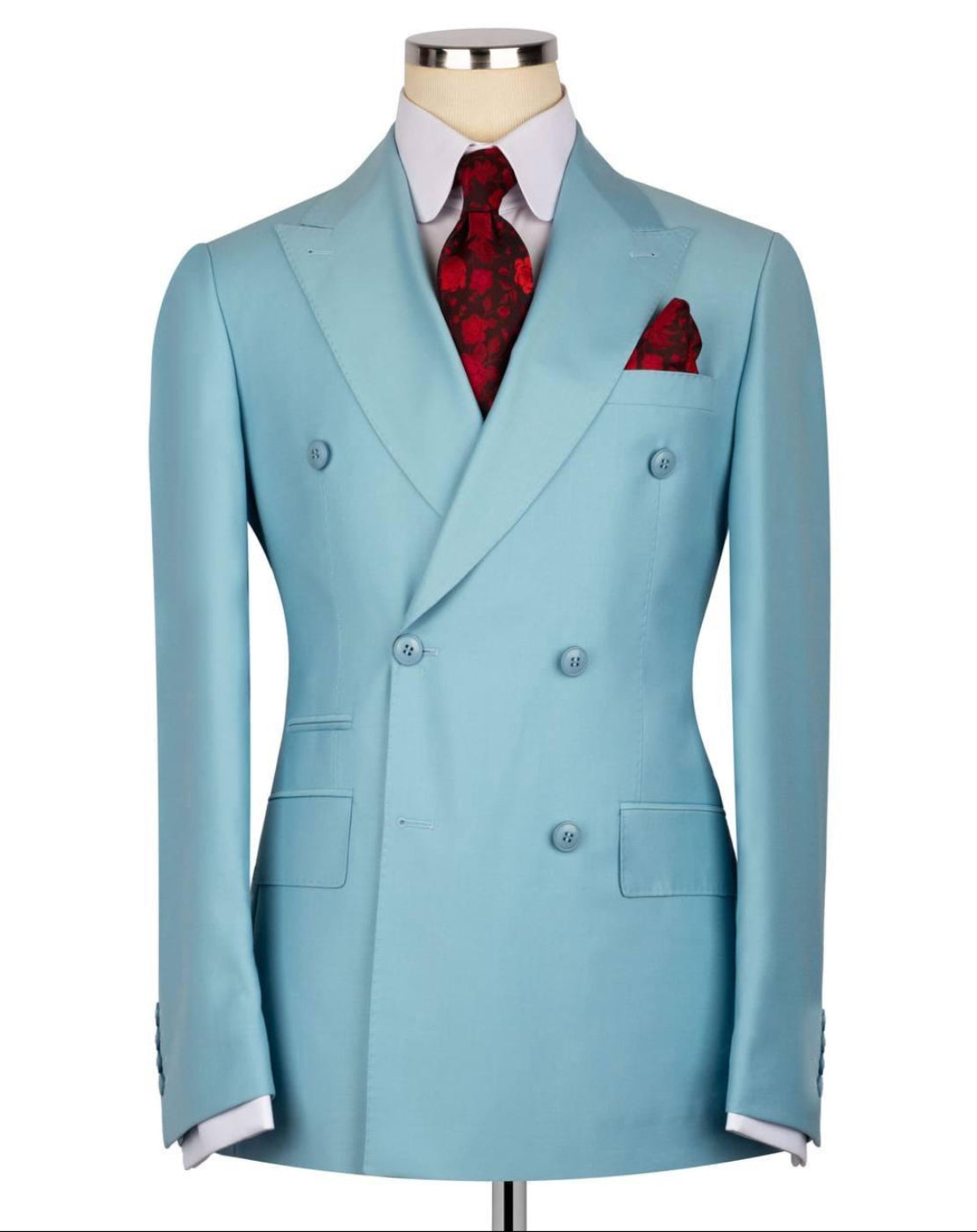 A light blue double-breasted suit jacket displayed on a mannequin torso, styled with a white dress shirt, a red patterned tie, and a matching red pocket square against a plain white background.