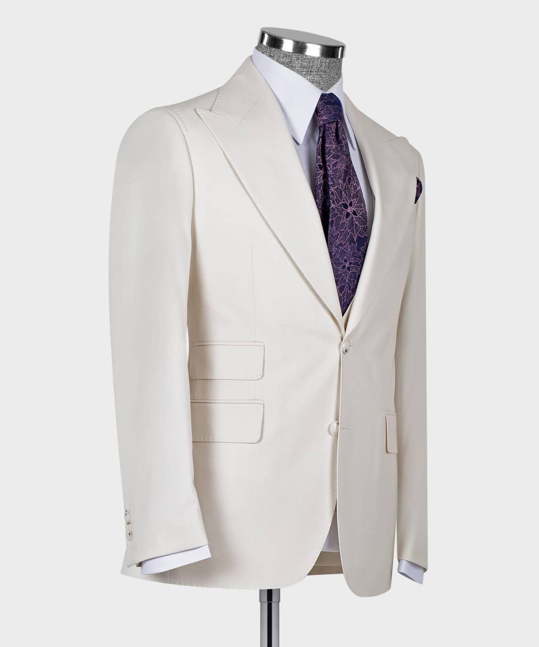 An off-white single-breasted suit jacket displayed on a mannequin torso, styled with a white dress shirt, a purple patterned tie, and a matching pocket square against a light gray background.