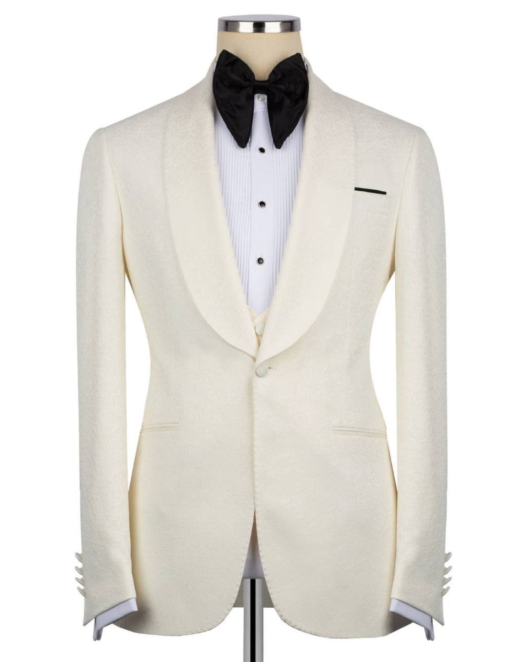 An ivory textured tuxedo jacket displayed on a mannequin torso, styled with a white pinstripe shirt, a black bow tie, and a black pocket square 