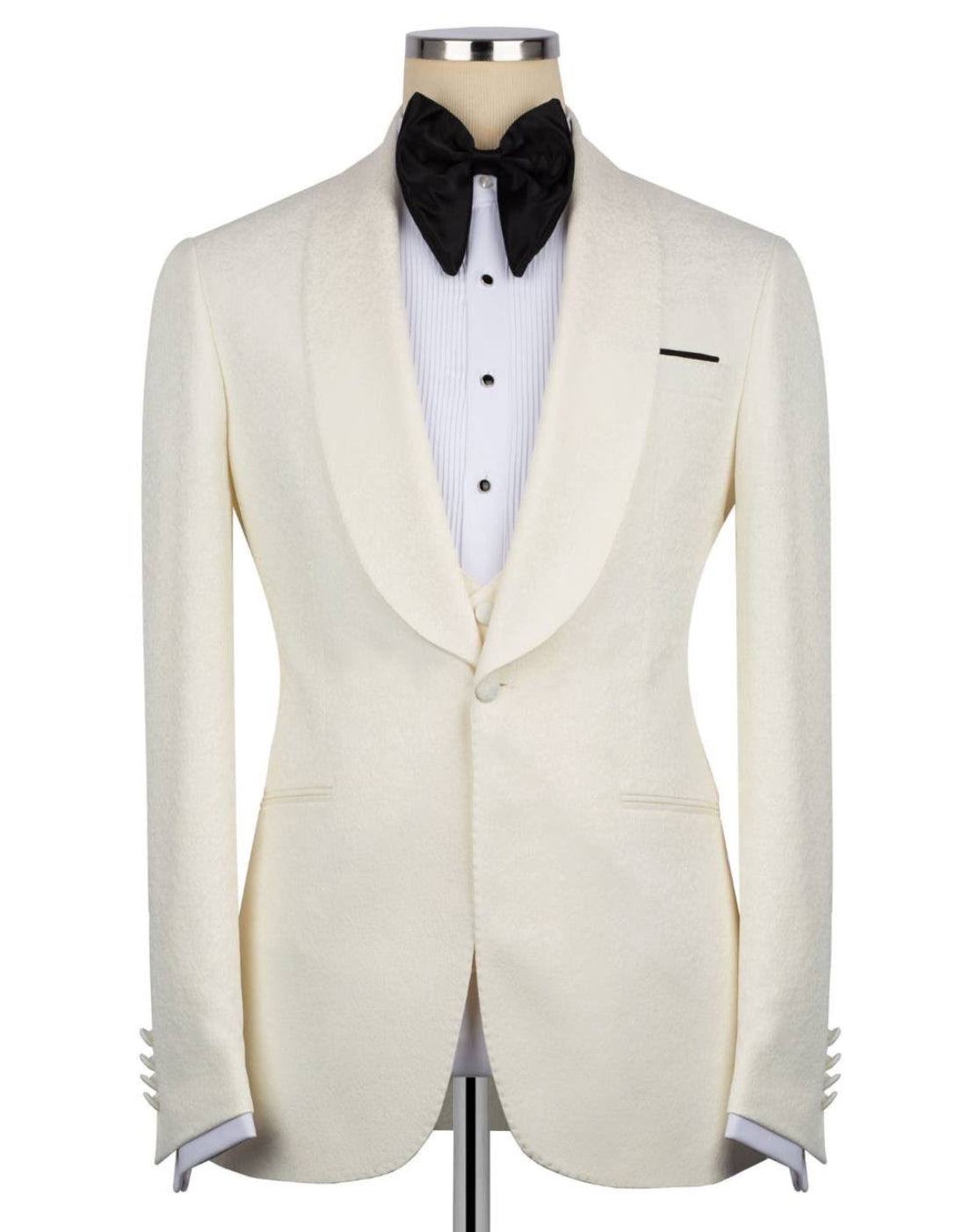 An ivory textured tuxedo jacket displayed on a mannequin torso, styled with a white pinstripe shirt, a black bow tie, and a black pocket square 