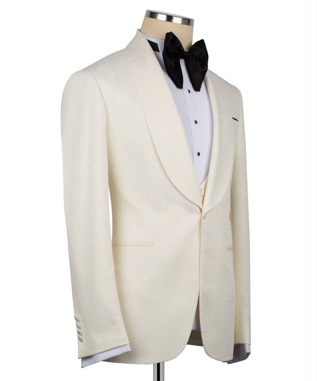 White tuxedo jacket on a mannequin with a black bow tie 