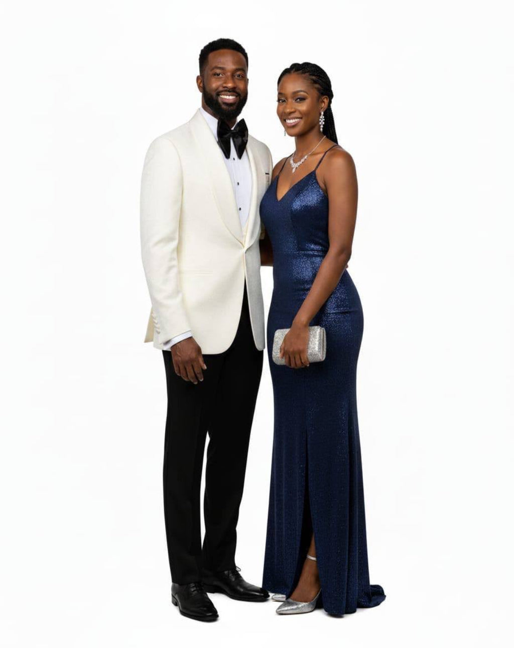A man and a woman posing in formal eveningwear against a solid white background. The man wears a white satin tuxedo jacket with black trousers and a black bow tie.