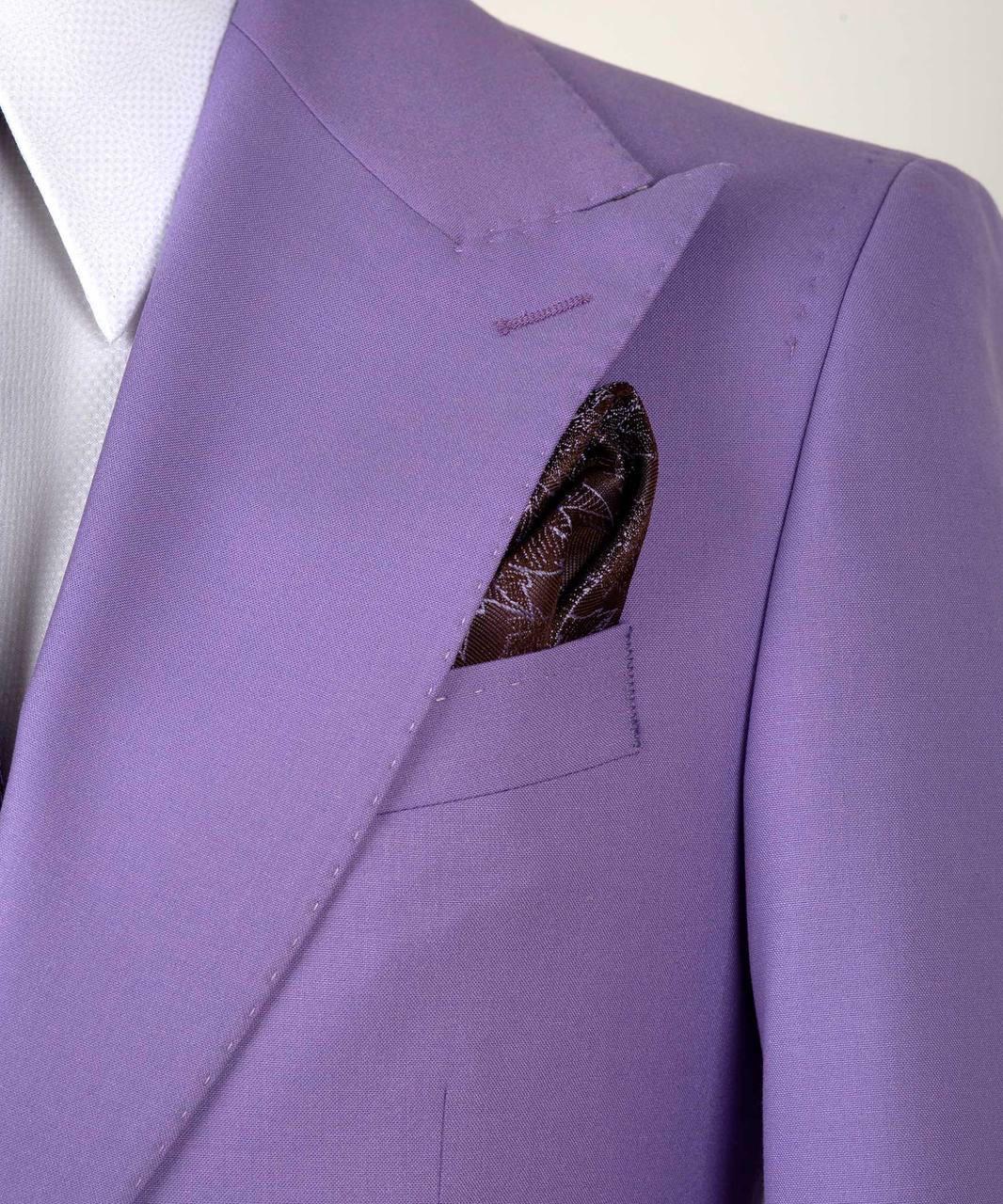 A close-up of a lavender purple suit jacket with a white dress shirt and a patterned brown pocket square in the breast pocket.