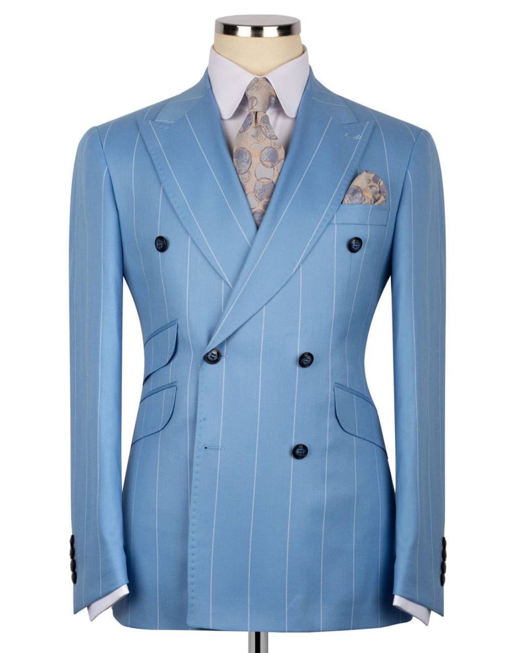 A light blue double-breasted pinstripe suit jacket displayed on a mannequin torso, styled with a light blue dress shirt, a patterned paisley tie, and a matching pocket square.