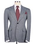 Gray suit jacket with a red patterned tie and pocket square on a mannequin against a white background