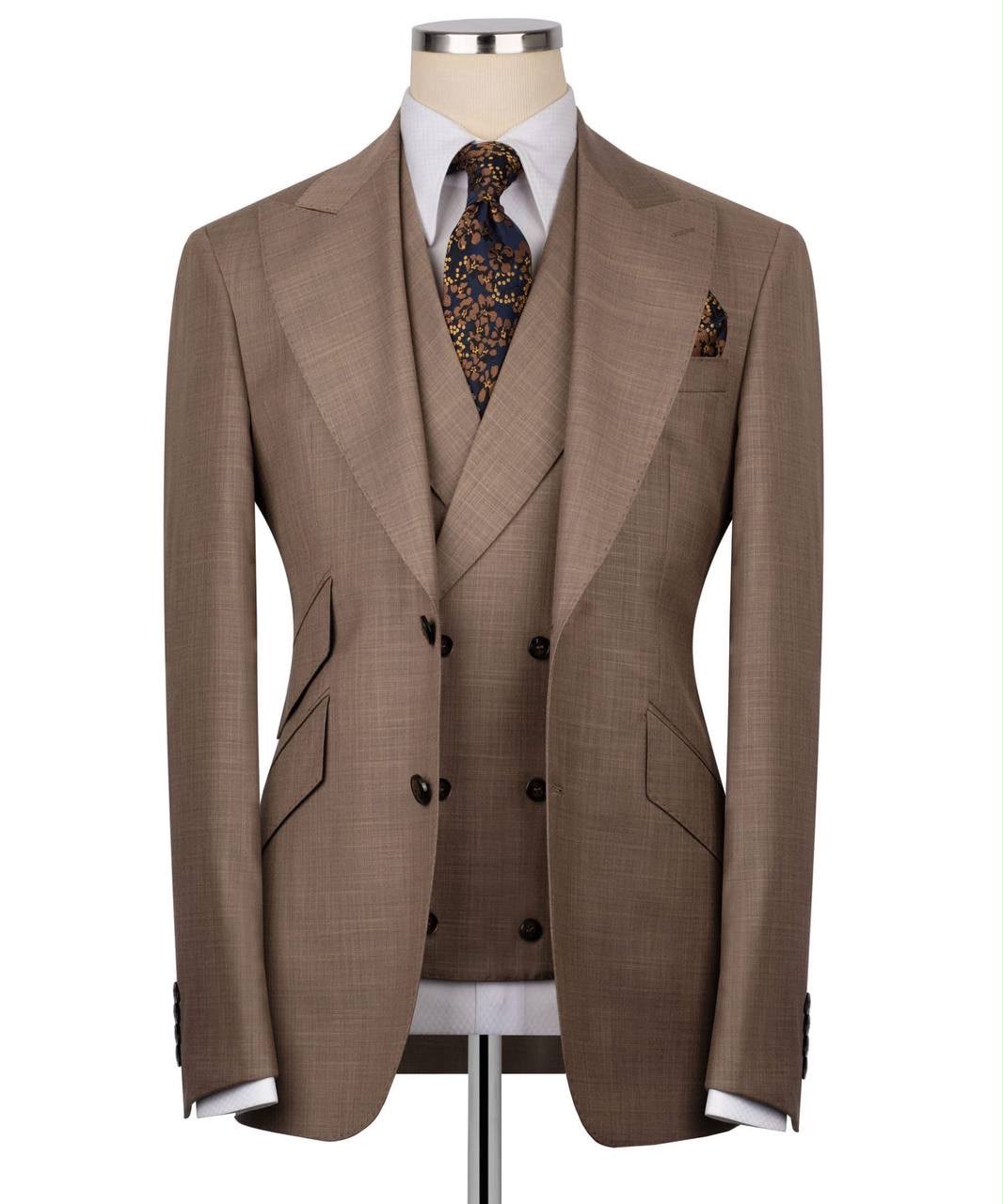 Brown suit jacket and vest on a mannequin with a white shirt and patterned tie.