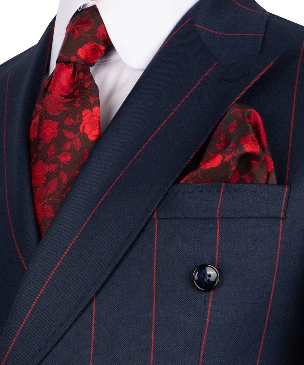 Navy suit with red floral tie and pocket square on a white background