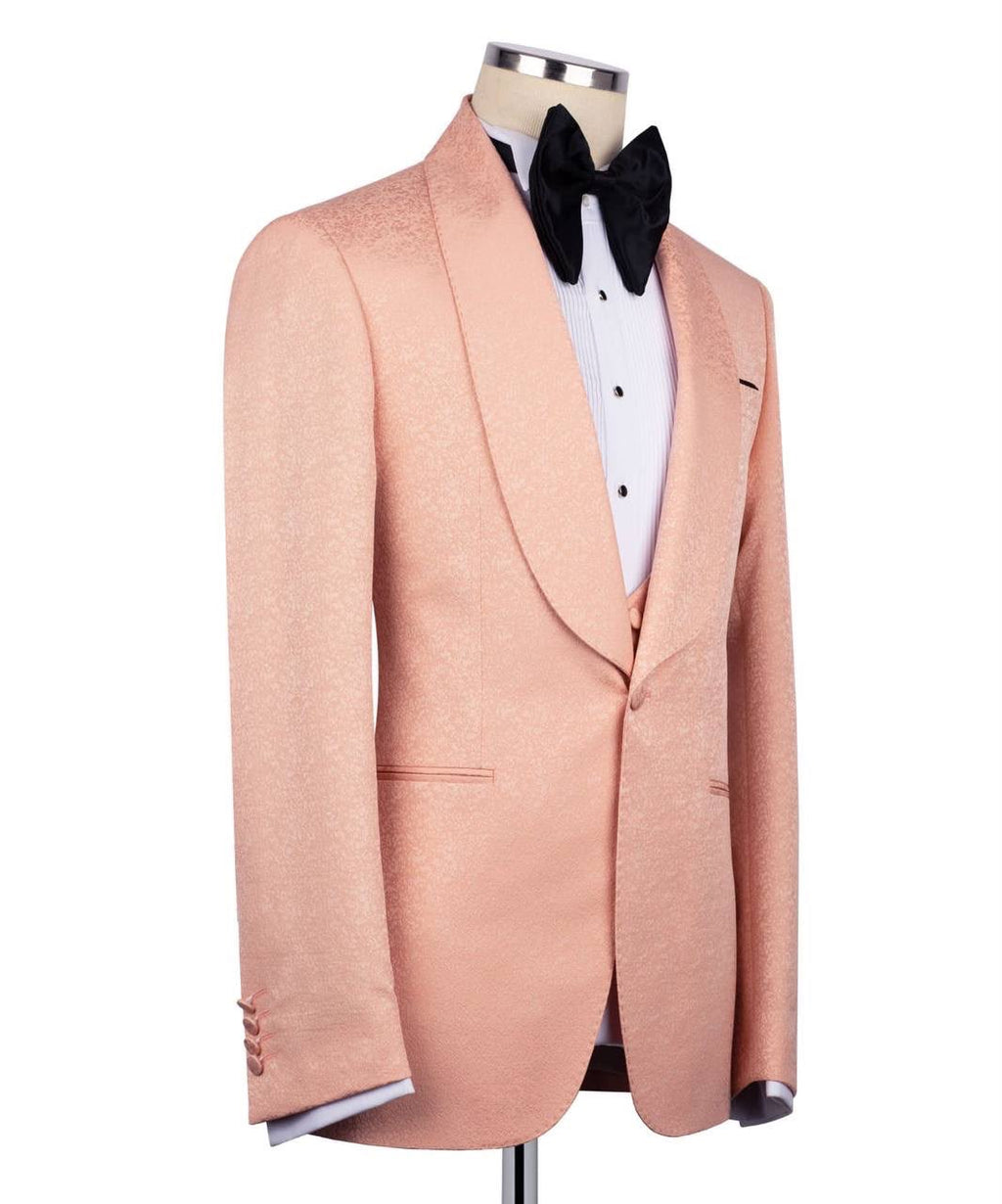 Pink tuxedo jacket on a mannequin with a white shirt and black bow tie against a white background