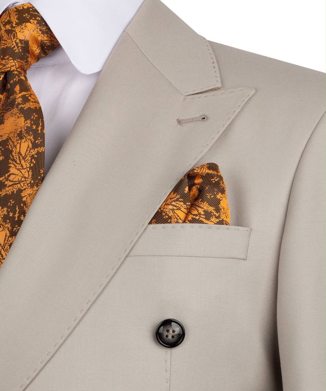 A close-up of a beige double-breasted suit jacket with a matching beige pocket square and a brown and gold patterned tie, styled with a white dress shirt.