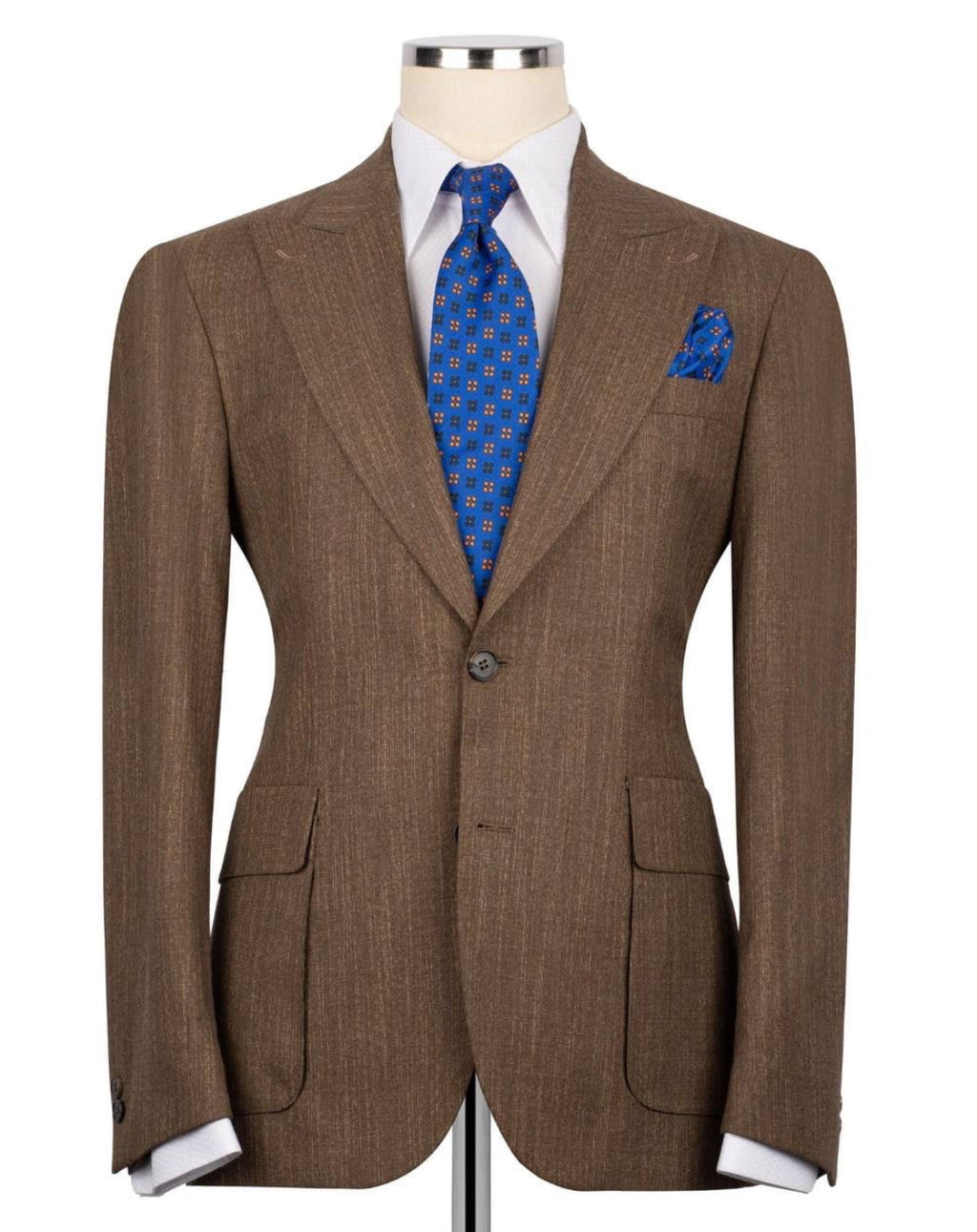 A brown textured suit jacket displayed on a mannequin torso, styled with a white dress shirt, a blue patterned tie, and a matching blue pocket square against a plain white background.