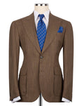 A brown textured suit jacket displayed on a mannequin torso, styled with a white dress shirt, a blue patterned tie, and a matching blue pocket square against a plain white background.