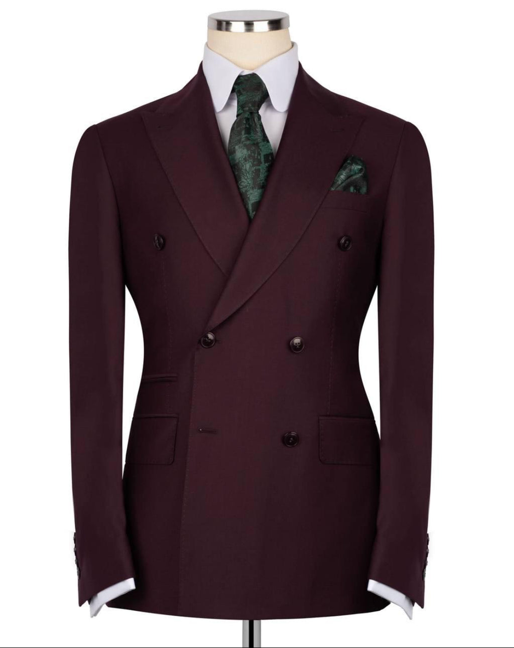 Burgundy double-breasted suit jacket on a mannequin with a white shirt and green patterned tie and pocket square.