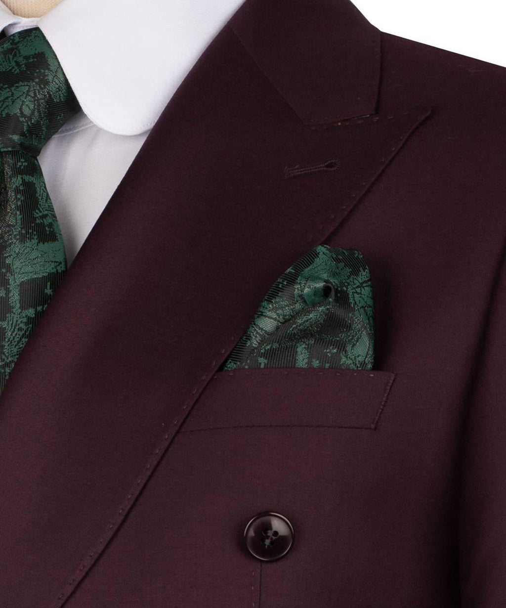 Close-up of a maroon suit jacket with a green patterned pocket square and tie.