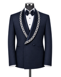 A navy blue satin tuxedo jacket displayed on a mannequin with a white dress shirt, a navy bow tie, and a prominent silver chain lapel. The jacket features a double-breasted design with a single front button and a decorative silver chain draped over the shoulders.
